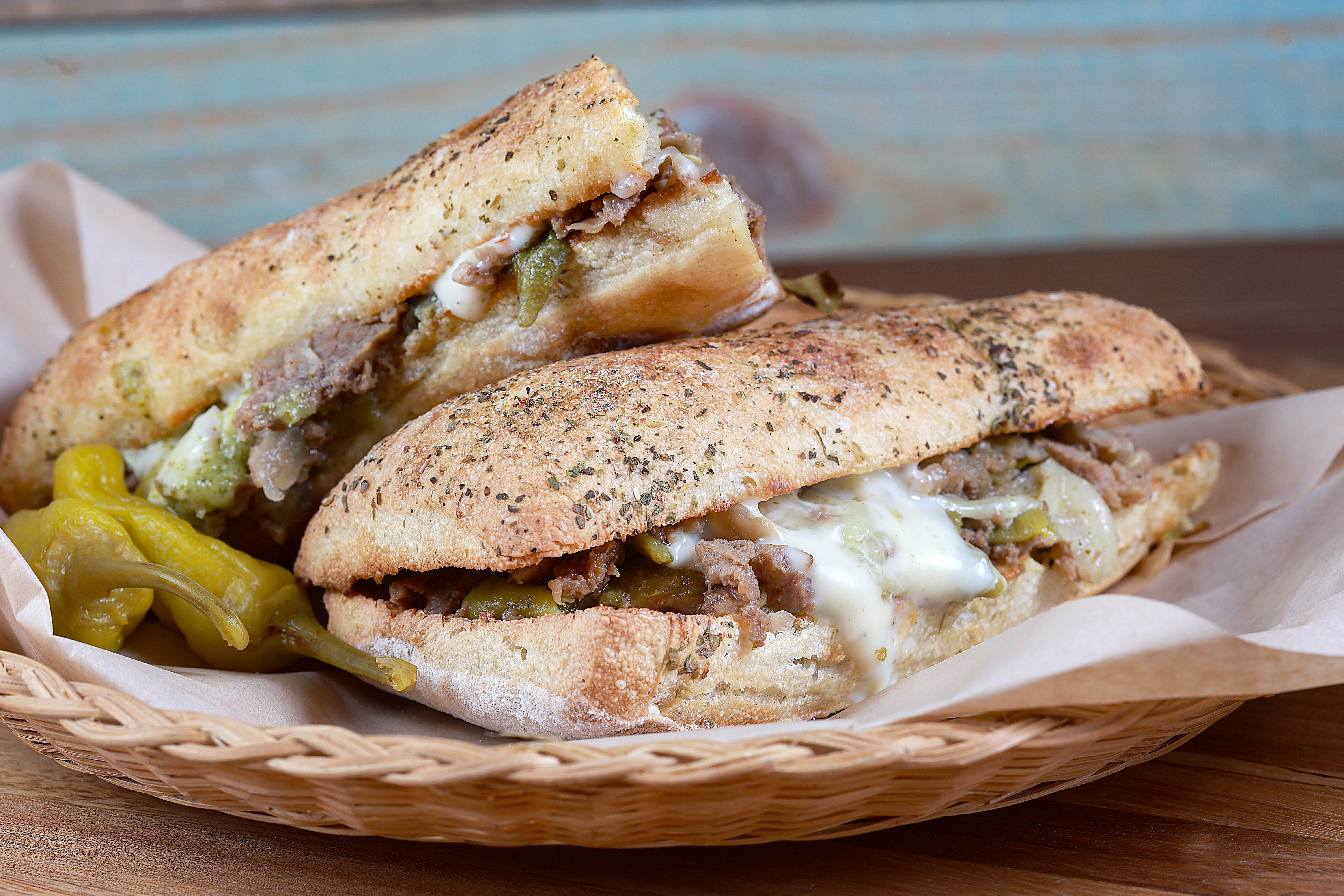 Close-up grilled meat sandwich with pickles on toasted flatbread
