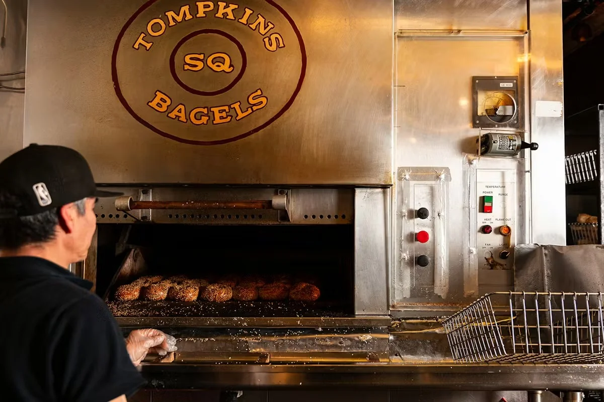Delicious gourmet burger with fresh toppings on a wooden table.