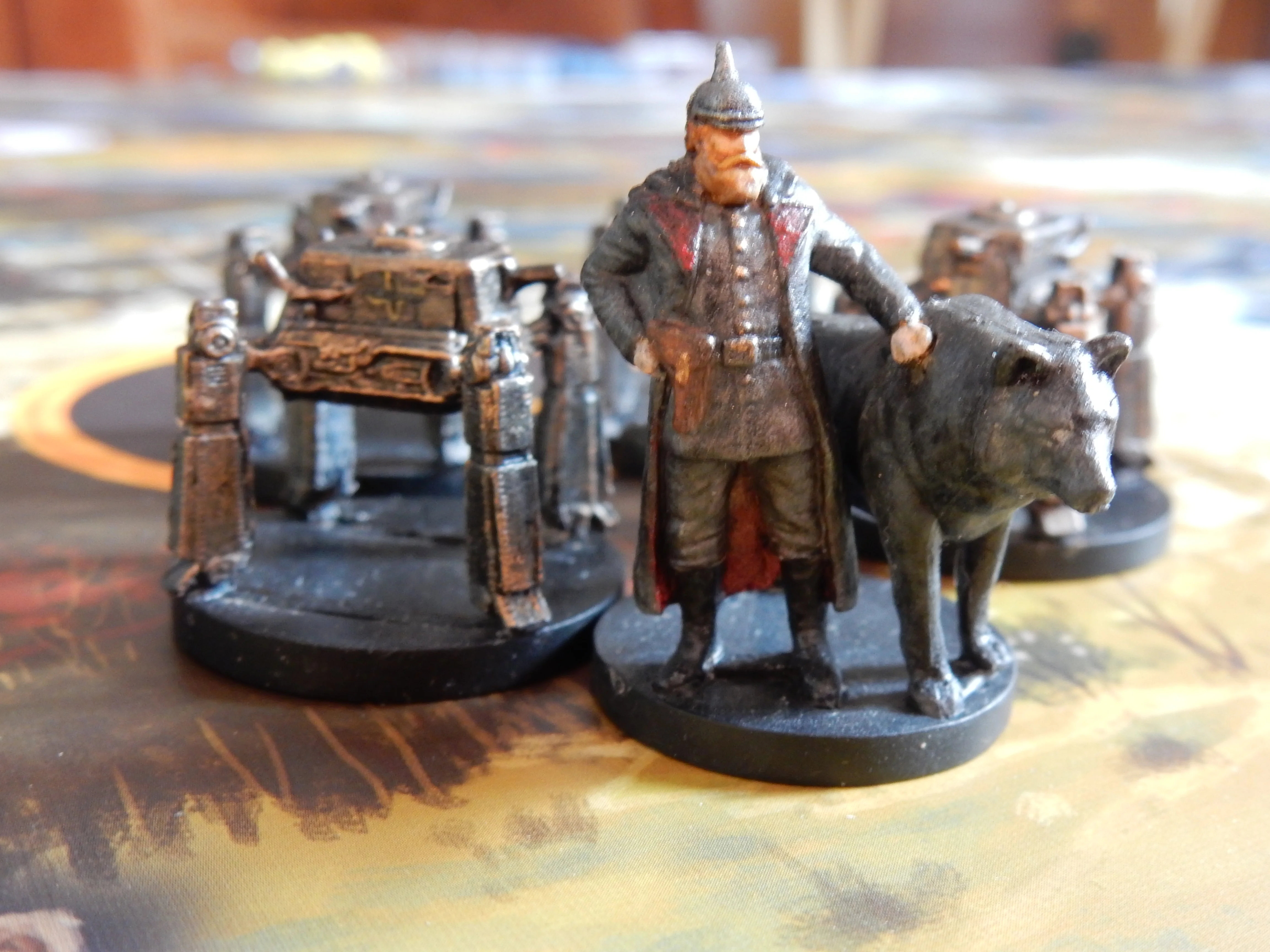 Miniature game figures including a soldier and a dog