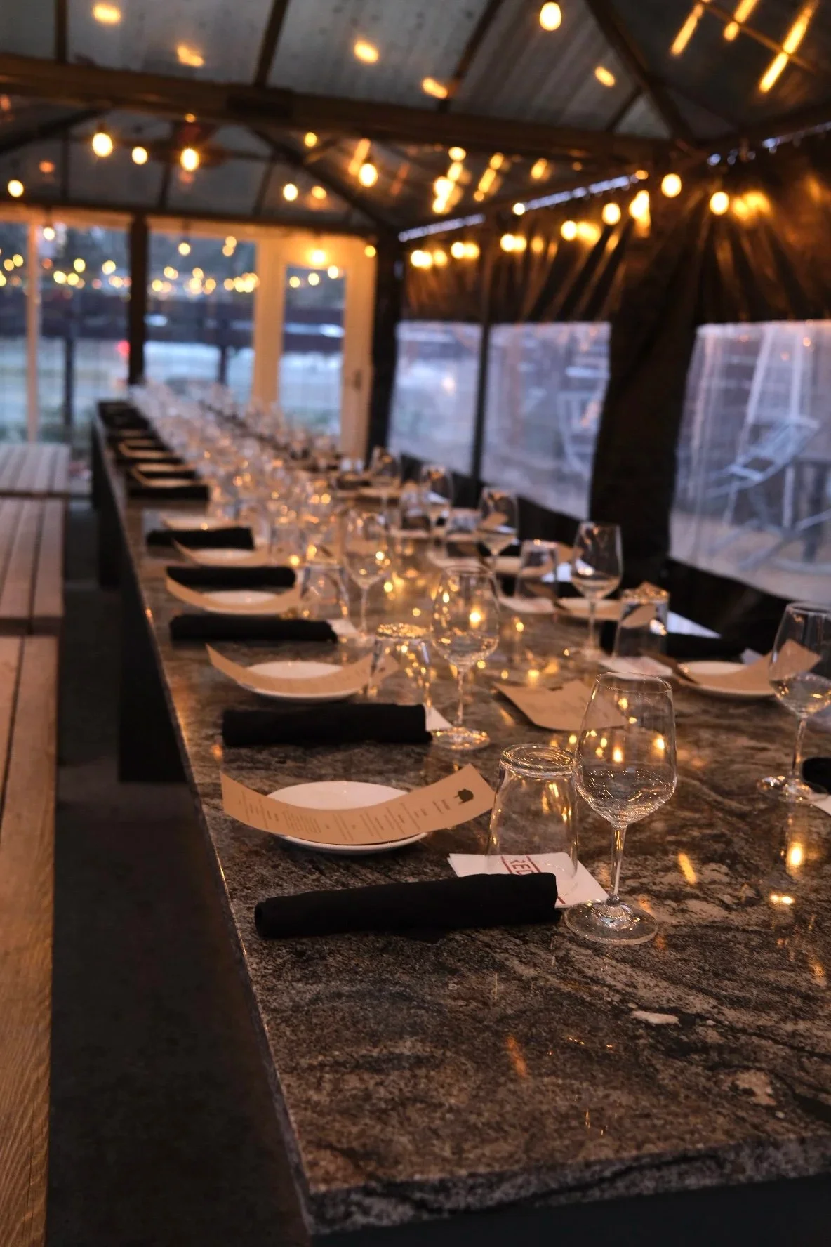 Outdoor patio setup for a private party with tables and decorations.