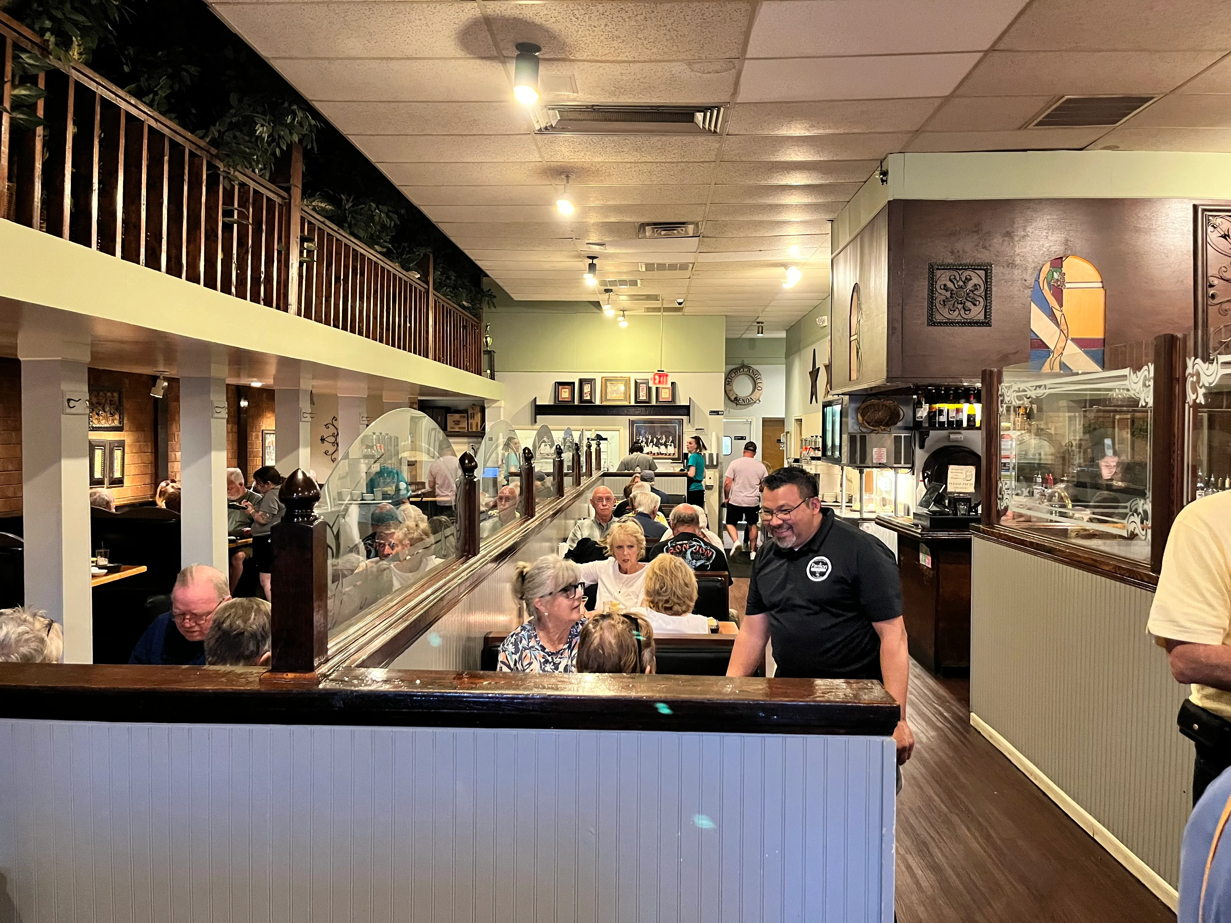 Cozy restaurant interior with diners enjoying their meals and warm lighting