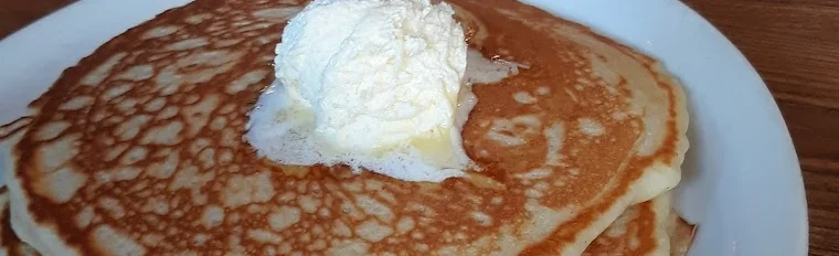 Fluffy American pancakes topped with whipped cream
