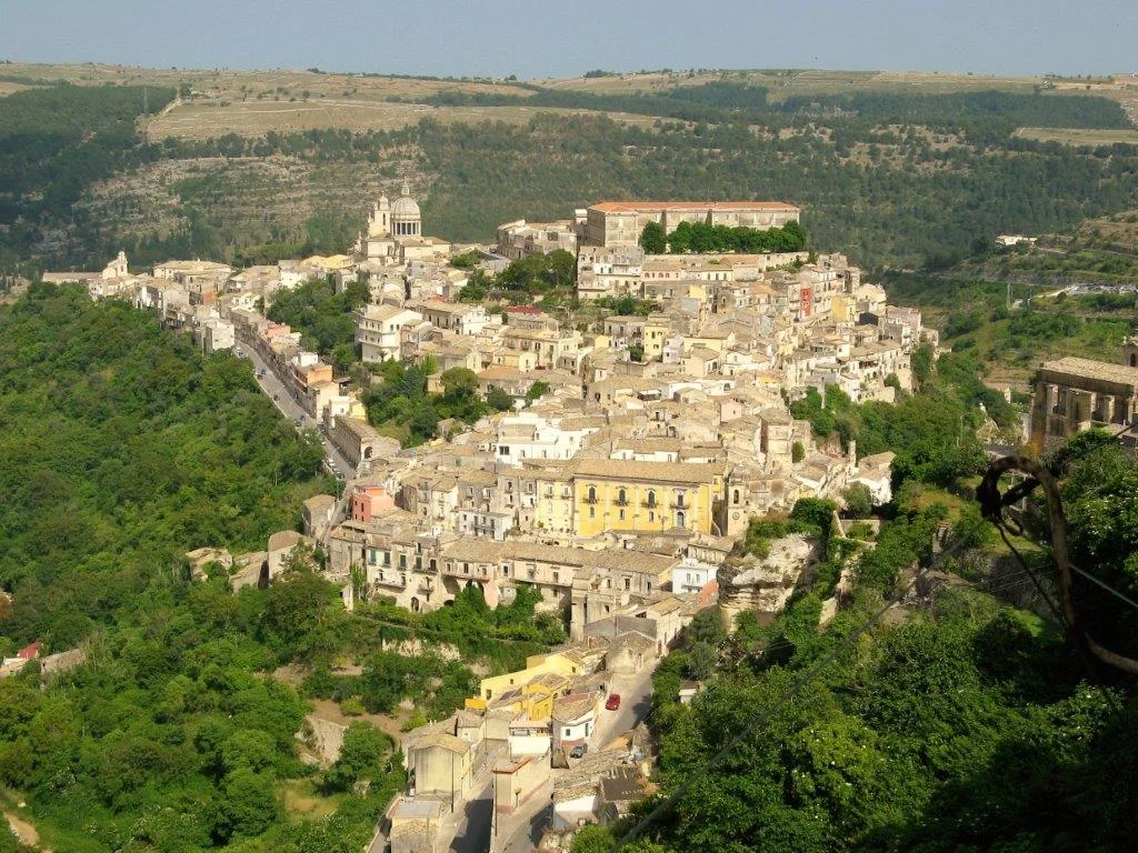 Aerial view of a historic hillside village in Sicily
