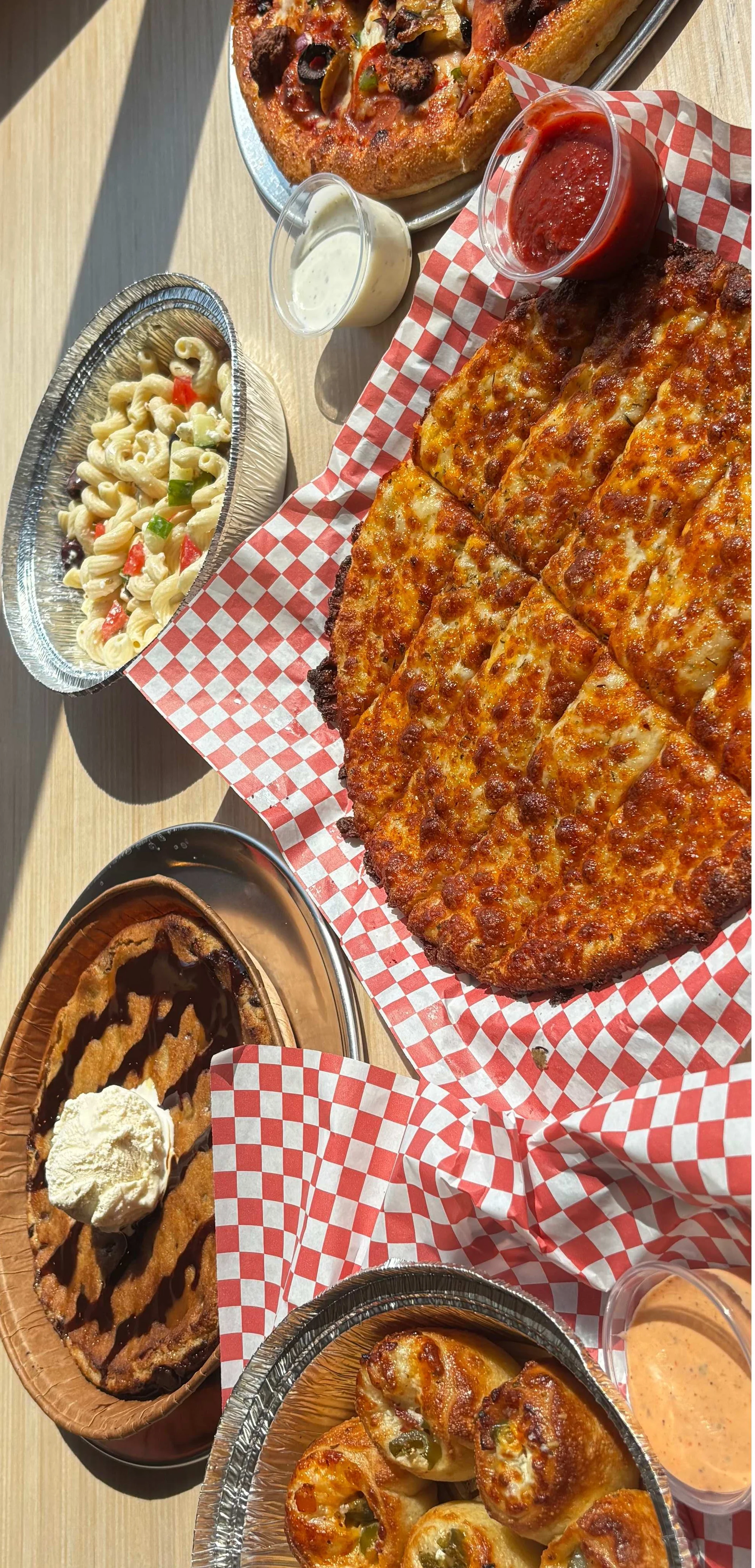 Assorted pizzas and pasta in a casual dining setting