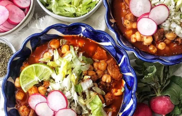 Hearty Mexican posole topped with fresh garnishes