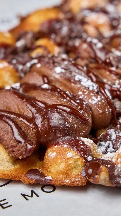 Delicious Belgian waffles drizzled with chocolate sauce