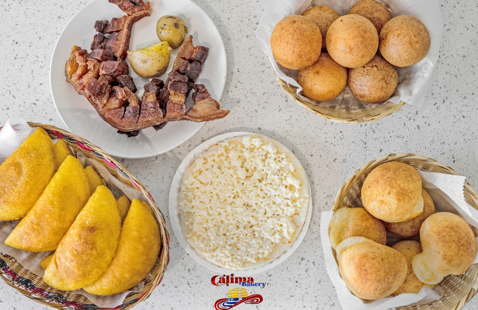 Traditional Colombian bandeja paisa with arepas and chicharrón