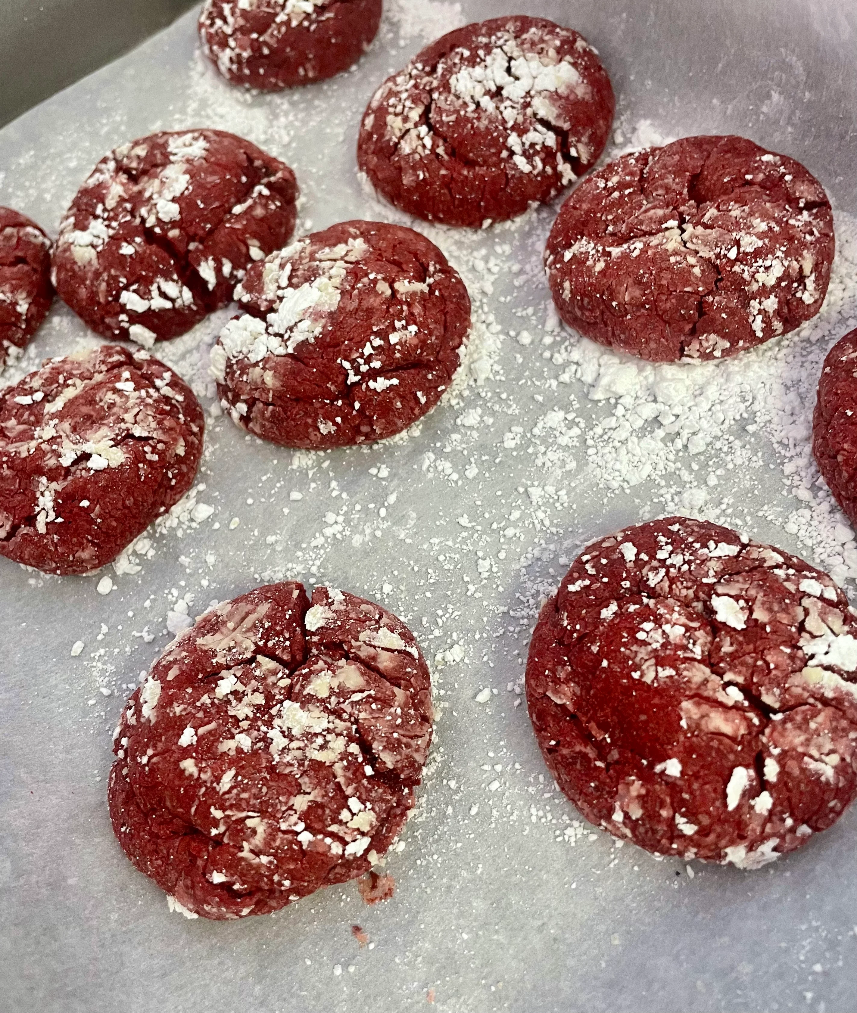 Red velvet crinkle cookies dusted with powdered sugar