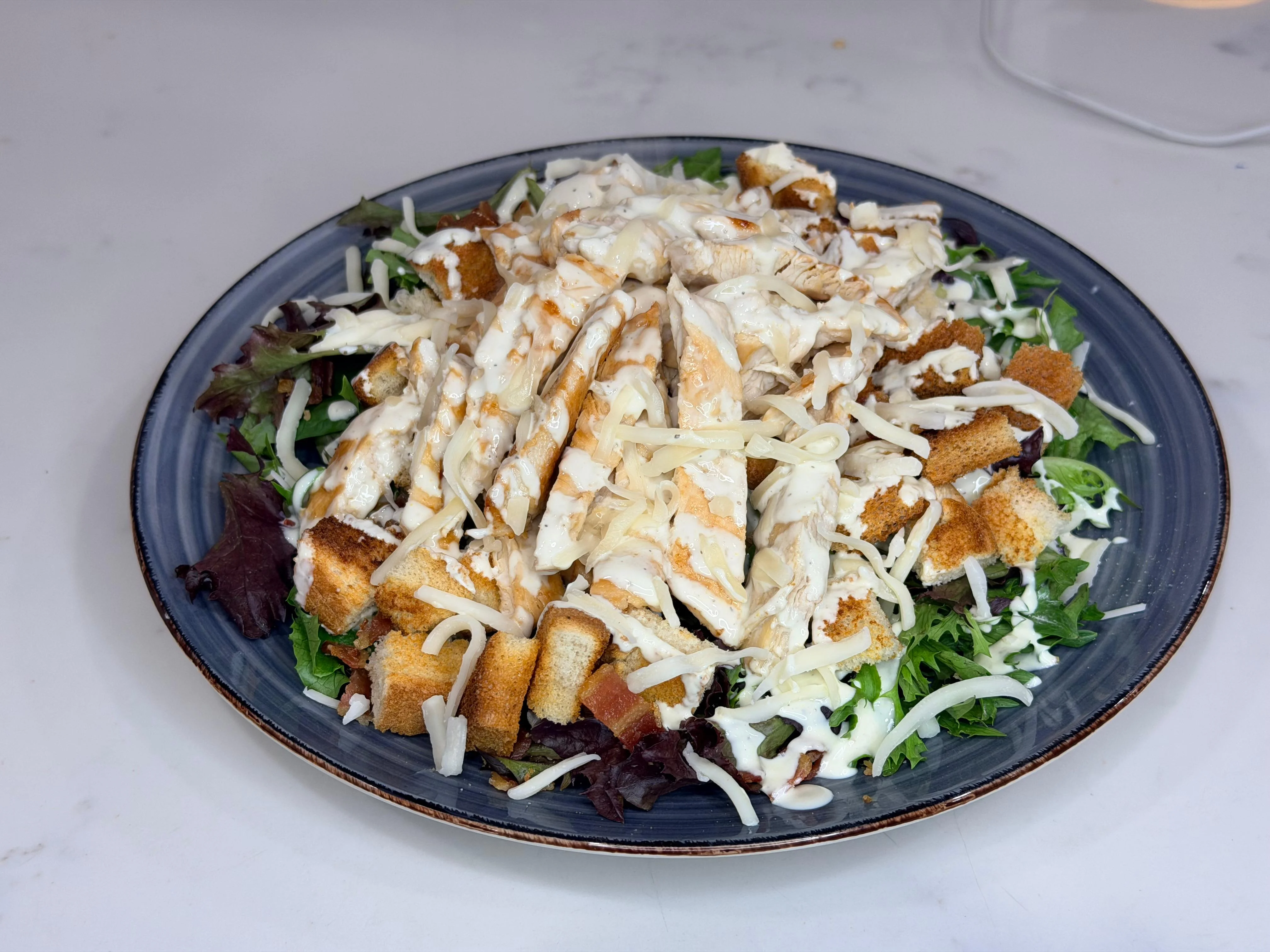 Grilled chicken Caesar salad with croutons and creamy dressing