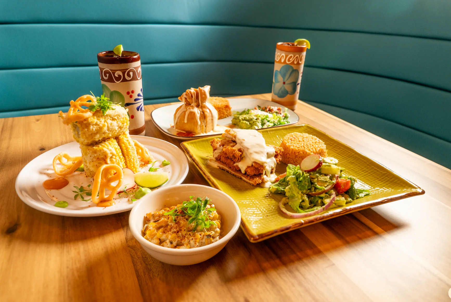 Colorful Mexican feast with various traditional dishes and drinks
