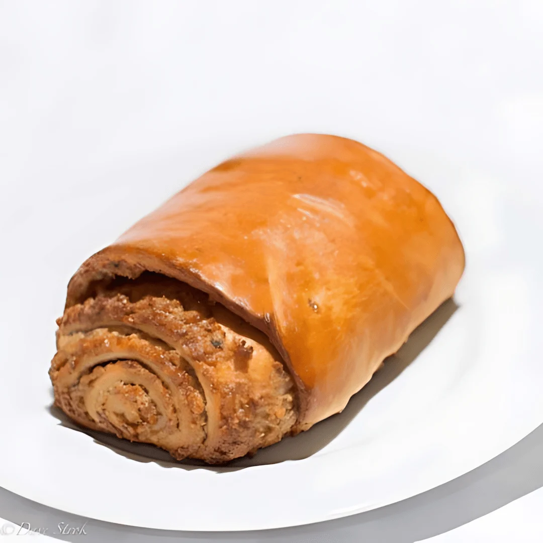 Freshly baked cinnamon roll loaf on a white plate