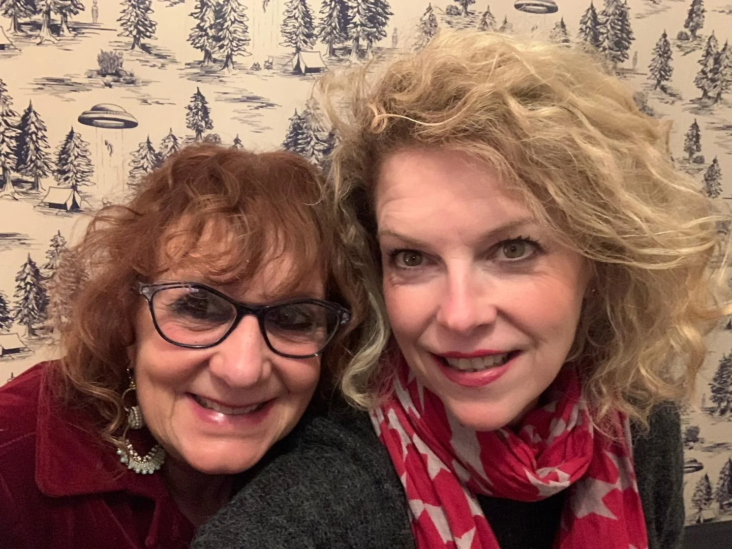 Two women smiling in a cozy restaurant setting
