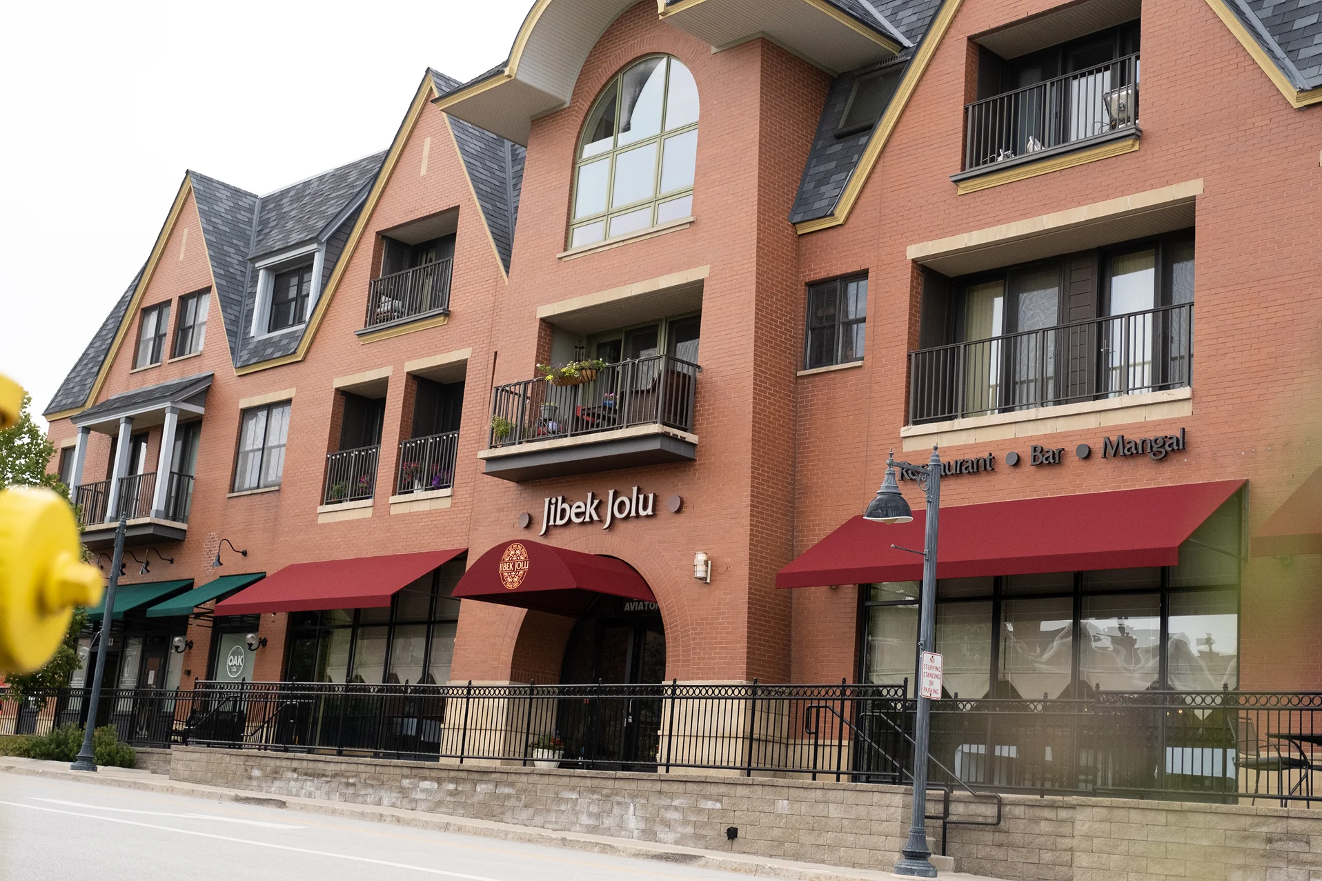 Exterior view of Jibek Jolu restaurant with red awnings