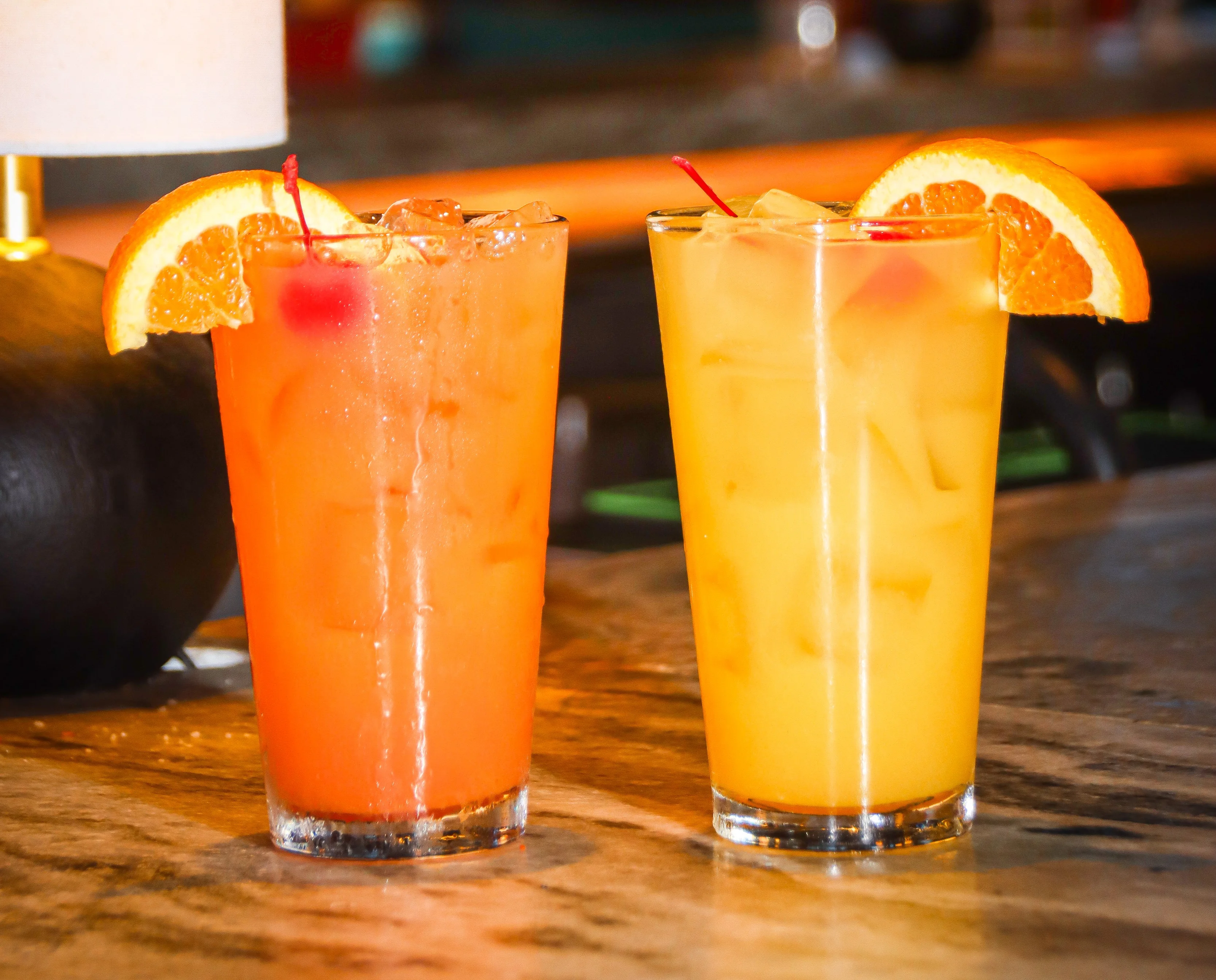 Colorful cocktails with fruit garnishes on a bar counter