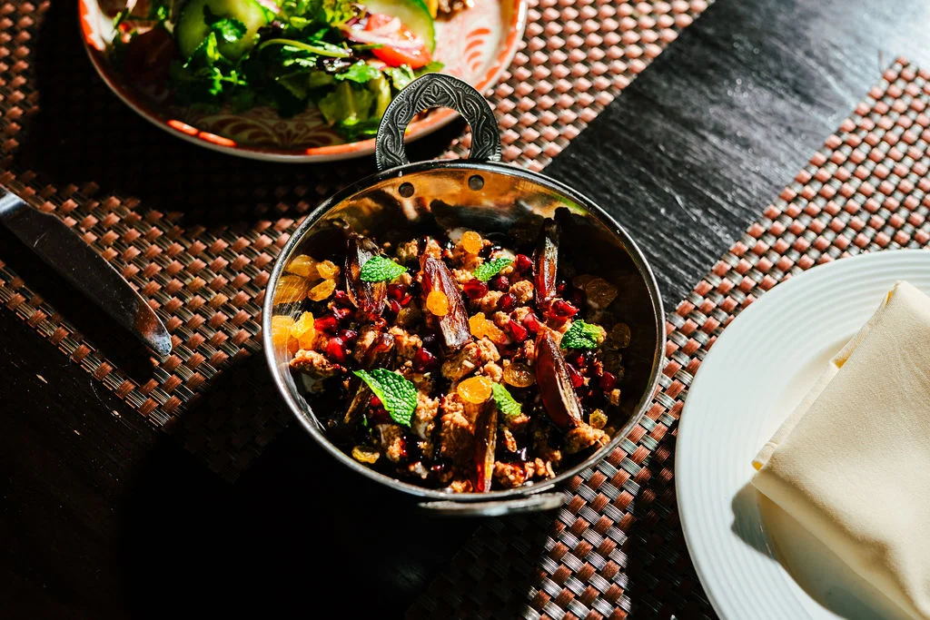 Persian khoresh with nuts and herbs in a traditional serving dish