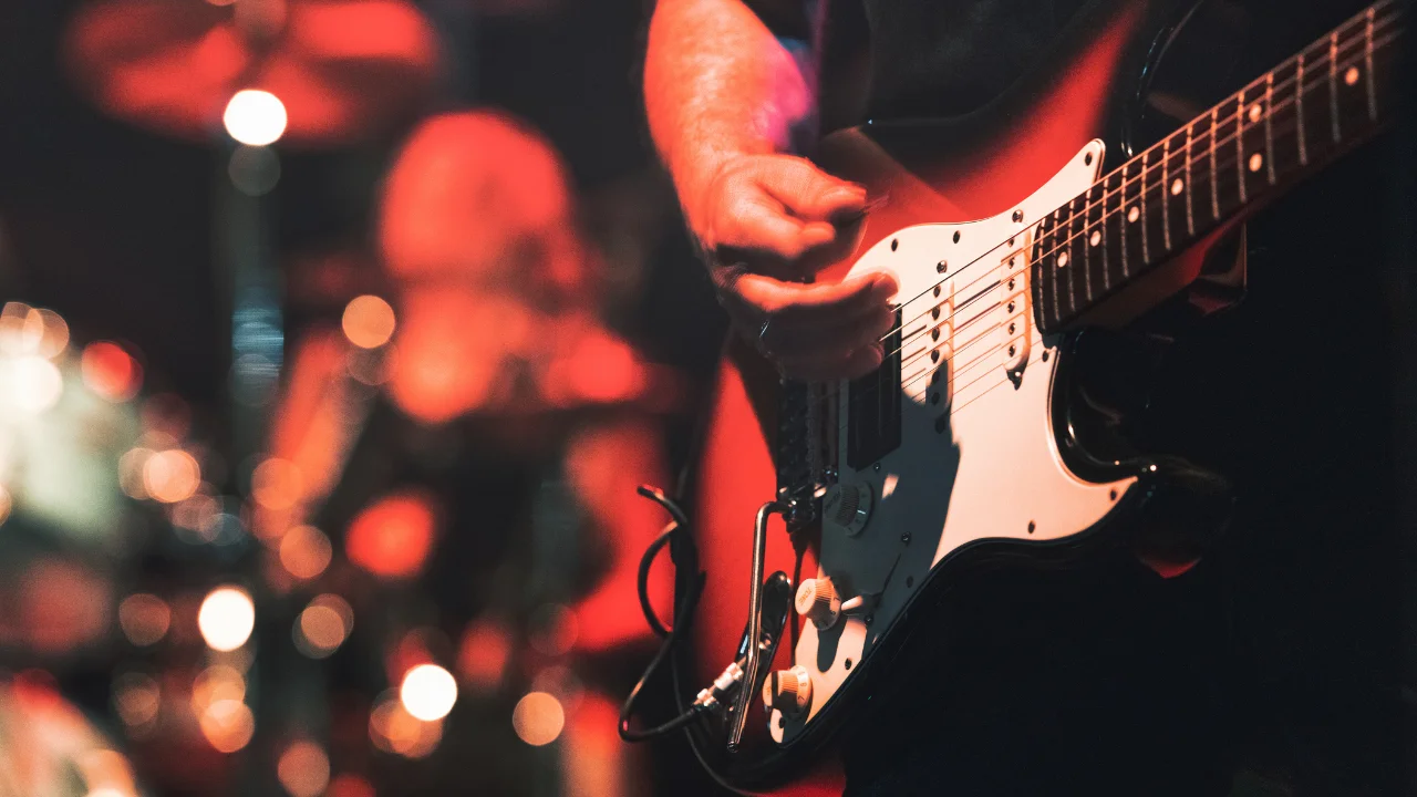 Musician playing electric guitar on stage