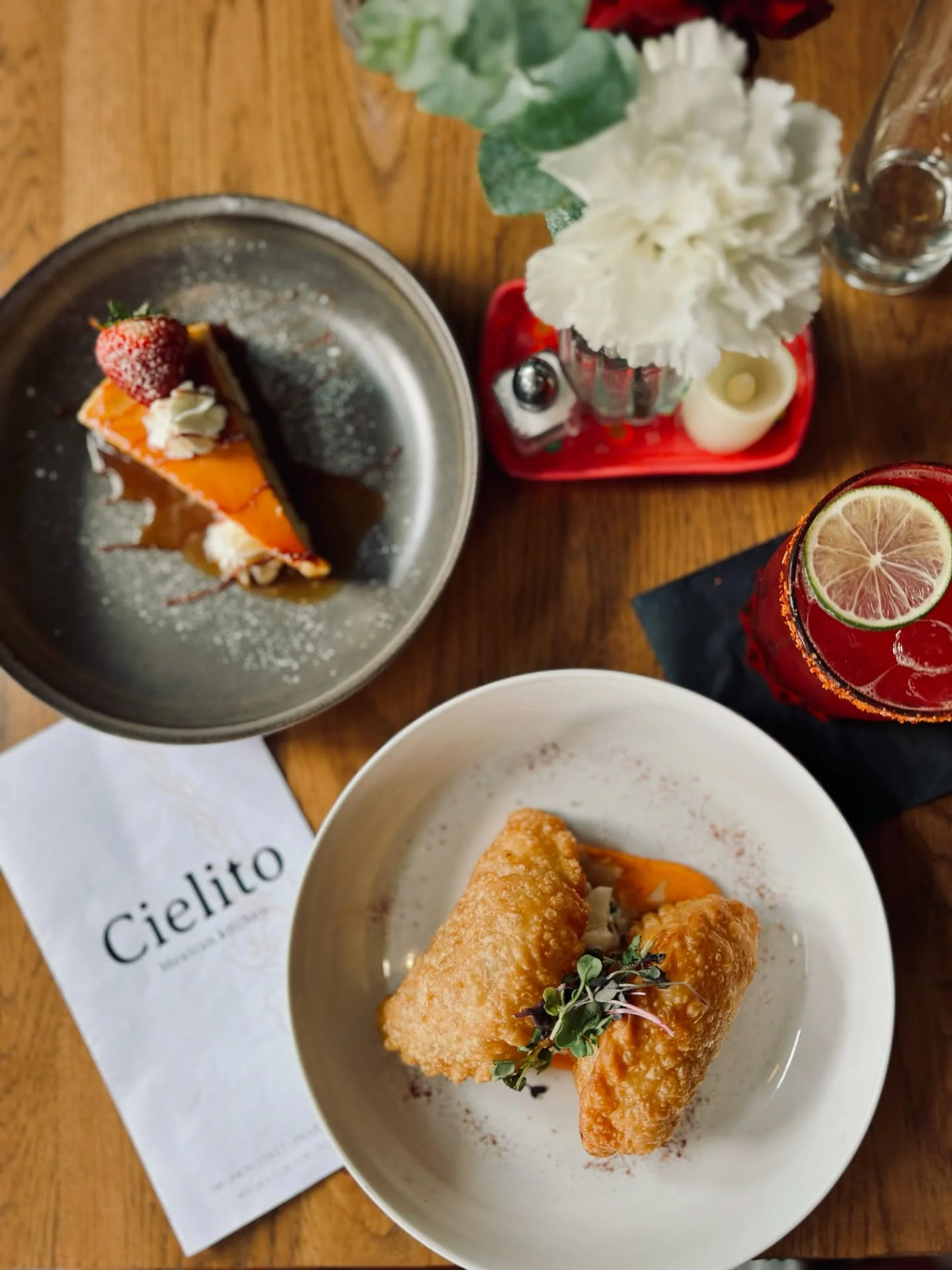 Crispy Mexican empanadas with sauce and dessert in a cozy restaurant setting
