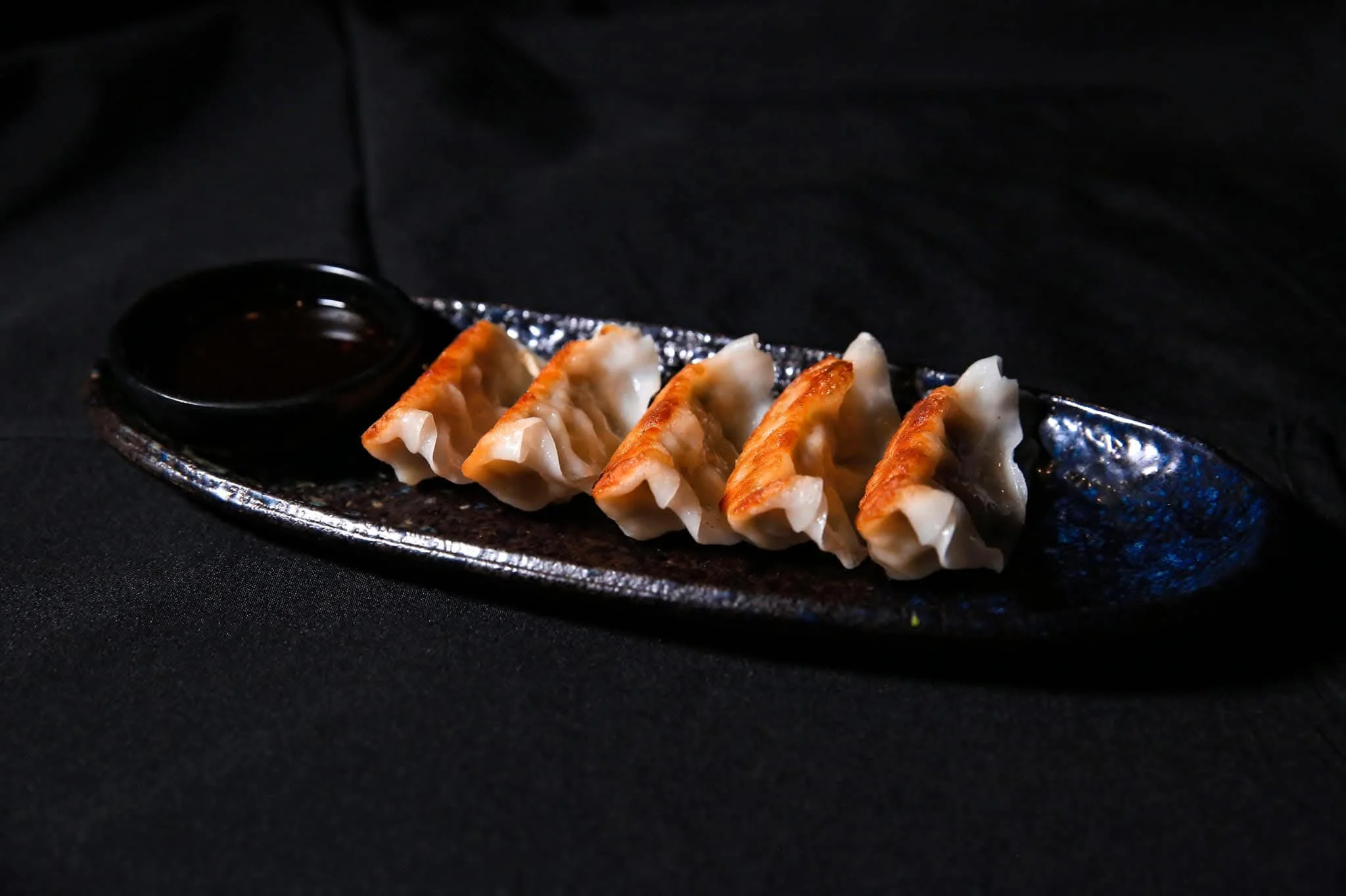 Japanese gyoza dumplings served with dipping sauce
