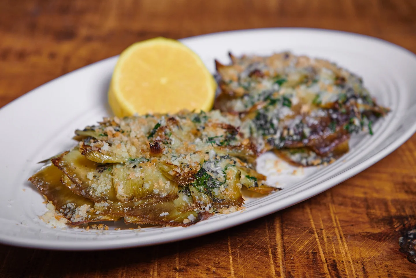 Stuffed artichokes with gremolata butter, Reggiano, bread crumbs, lemon, and fresh herbs