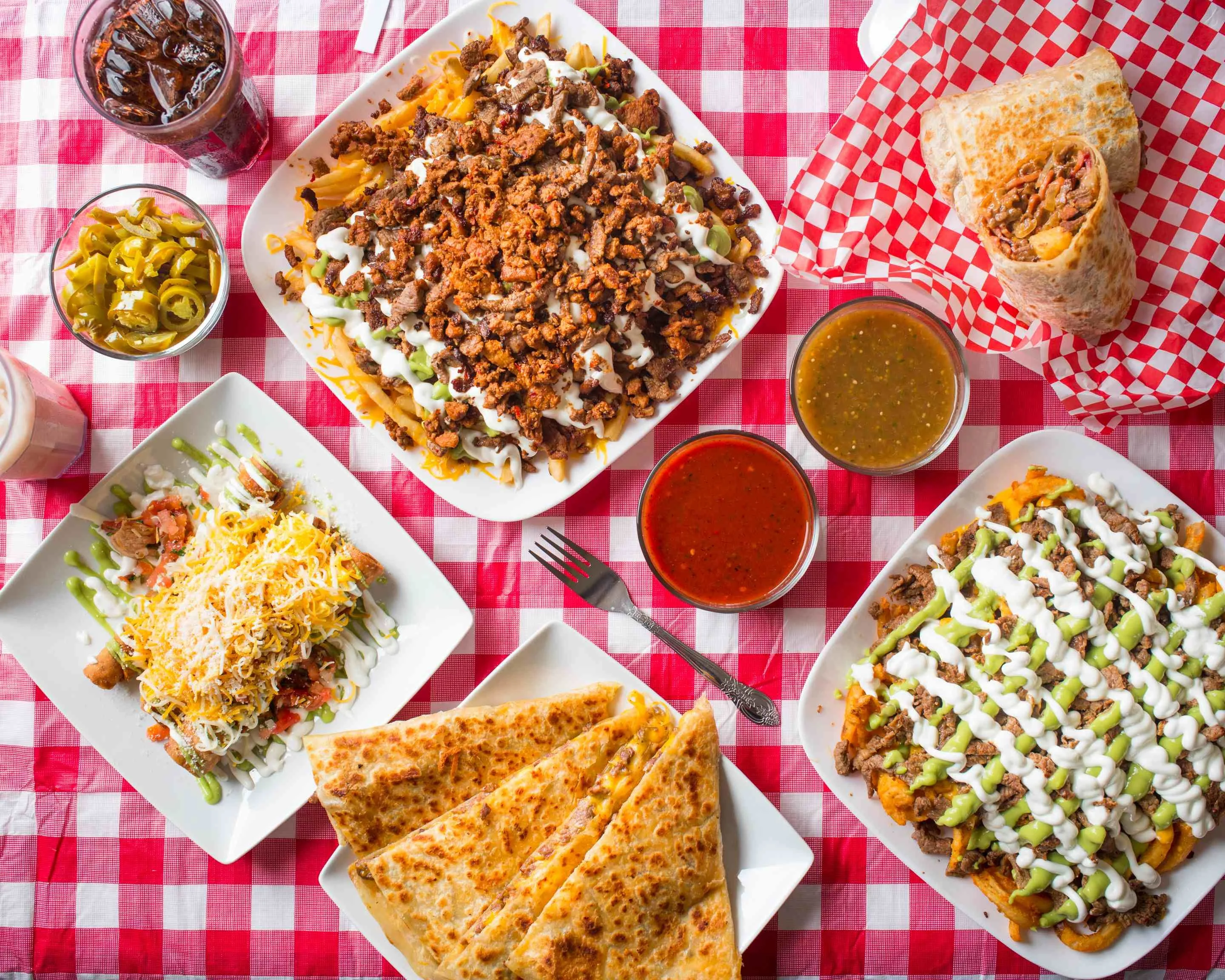 Loaded nachos with grilled meats and sauces