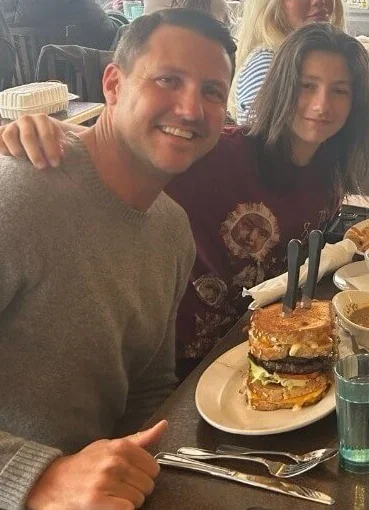 Giant cheeseburger stack in a casual dining setting