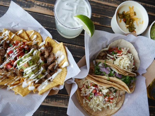 Delicious Mexican tacos and nachos with guacamole