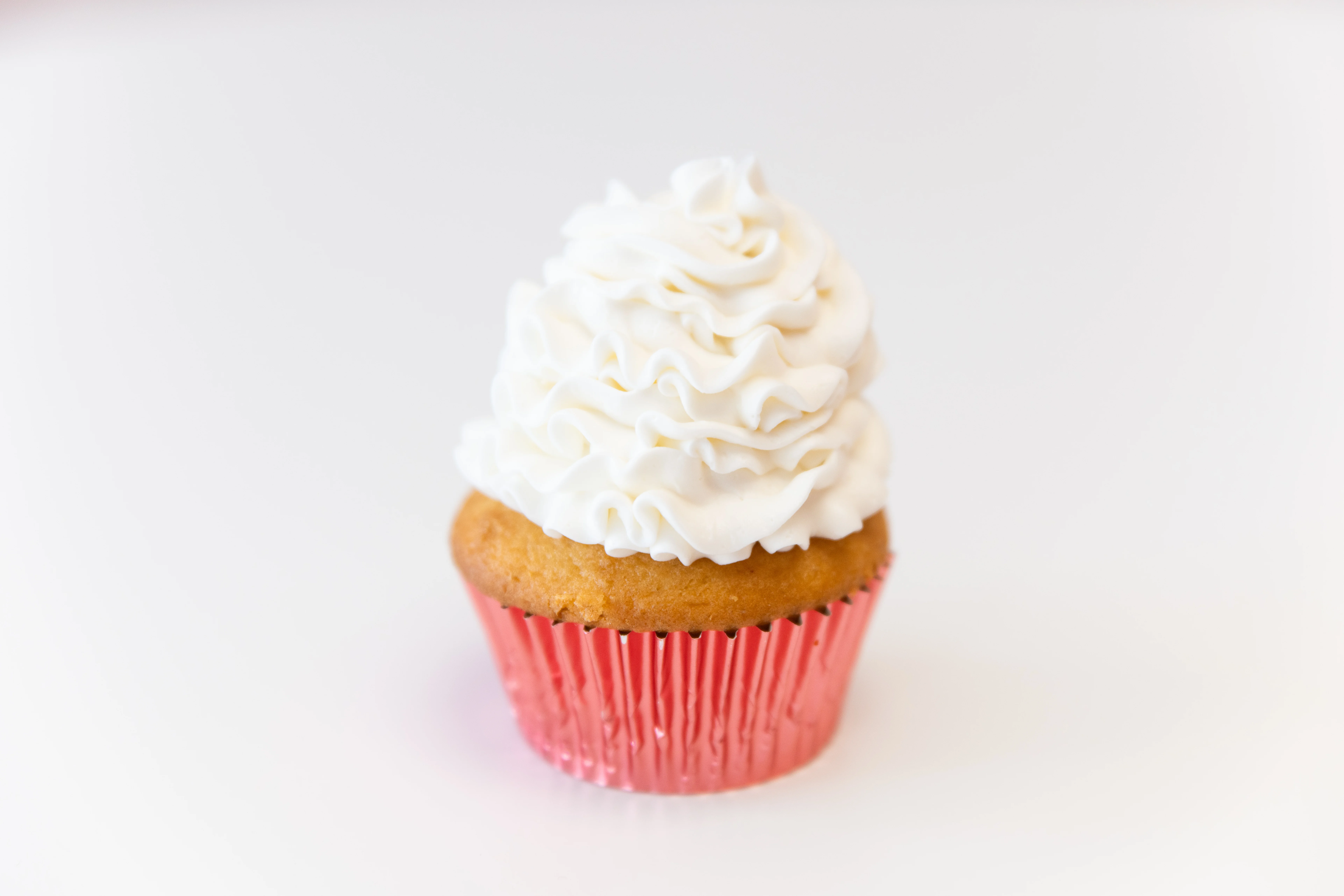 Delicious vanilla cupcake with fluffy white frosting