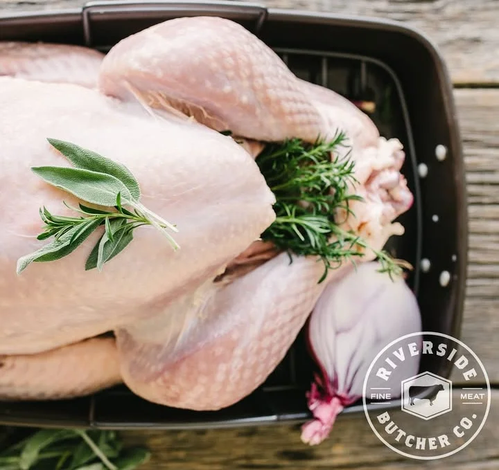 Raw turkey ready for roasting with fresh herbs