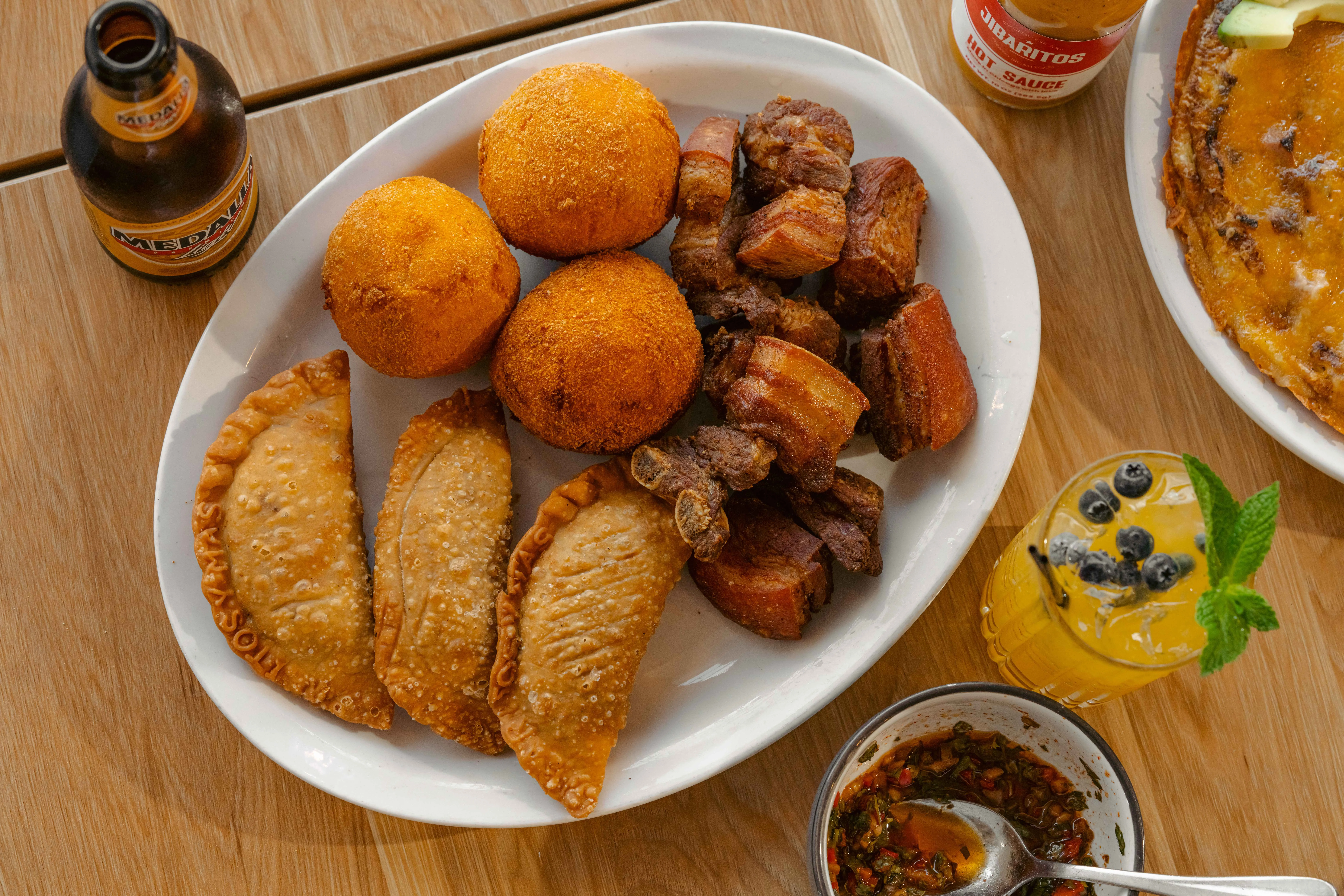Plate of Puerto Rican mofongo with empanadas and fried pork