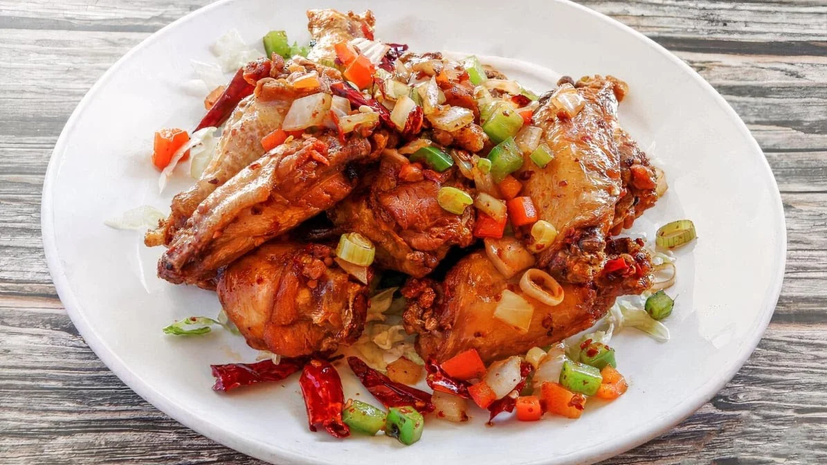 Spicy Sichuan chicken wings with vegetables