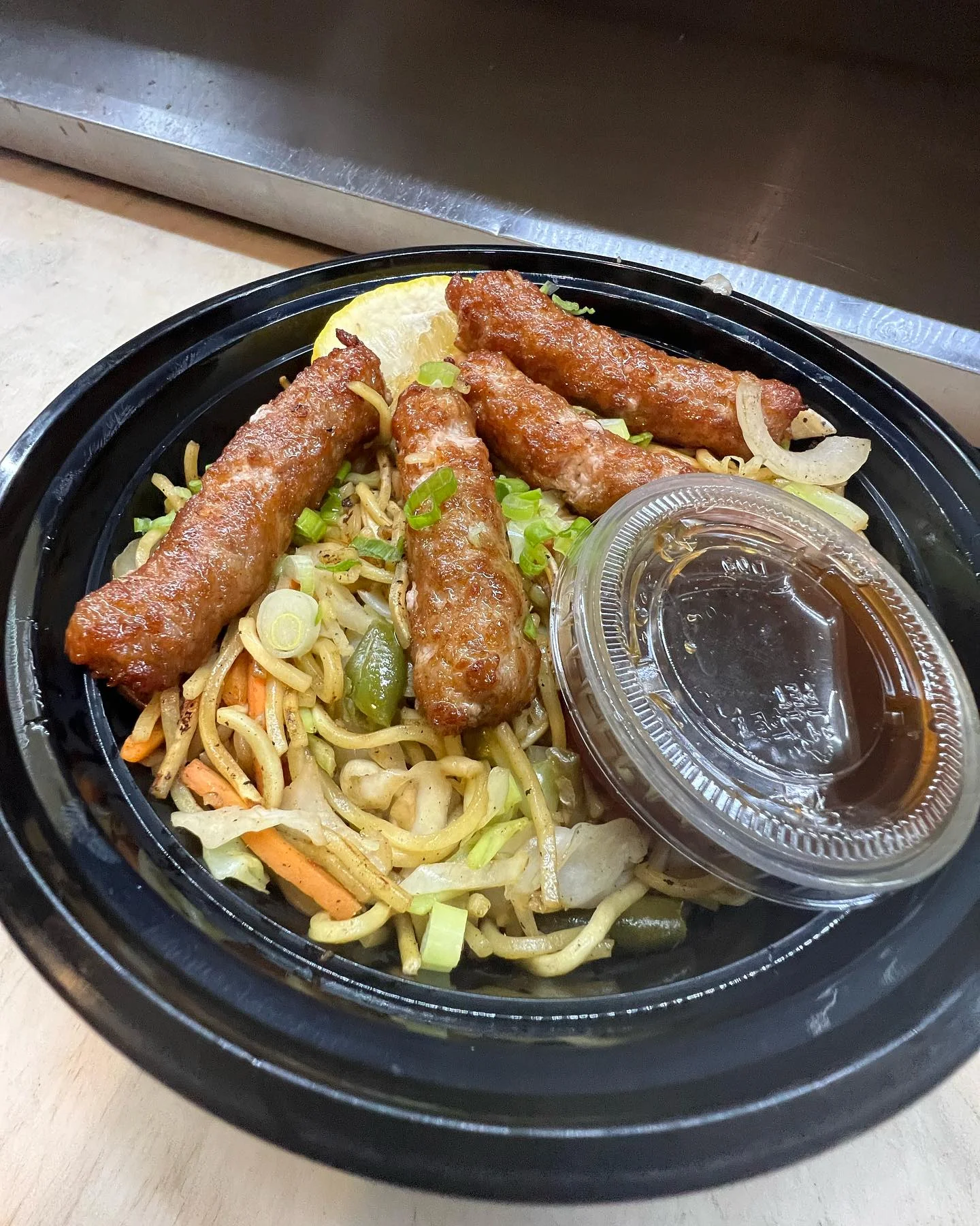 Chinese chow mein with crispy spring rolls