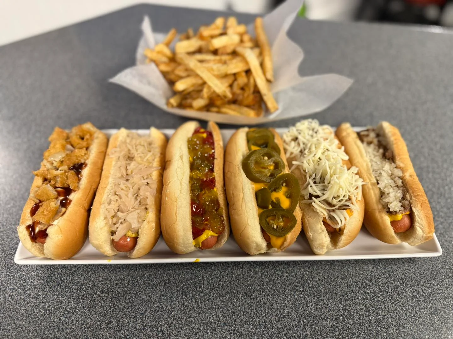 Variety of gourmet hot dogs with unique toppings