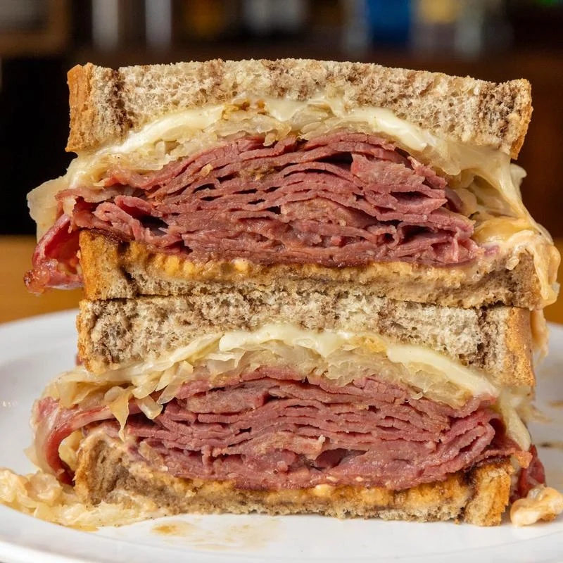 Grilled Reuben sandwich with melted cheese and sauerkraut on toasted bread