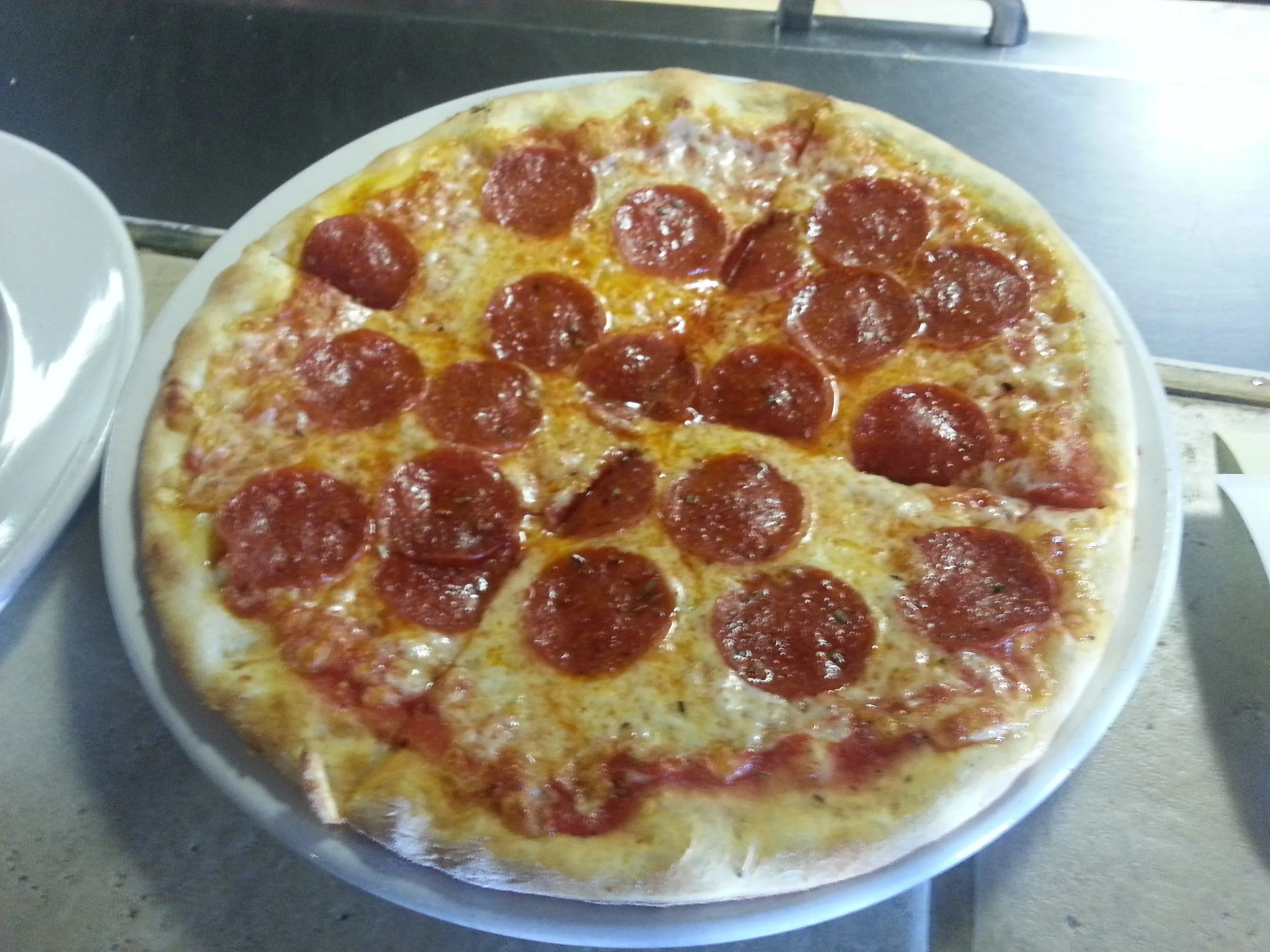 Classic pepperoni pizza on a white plate