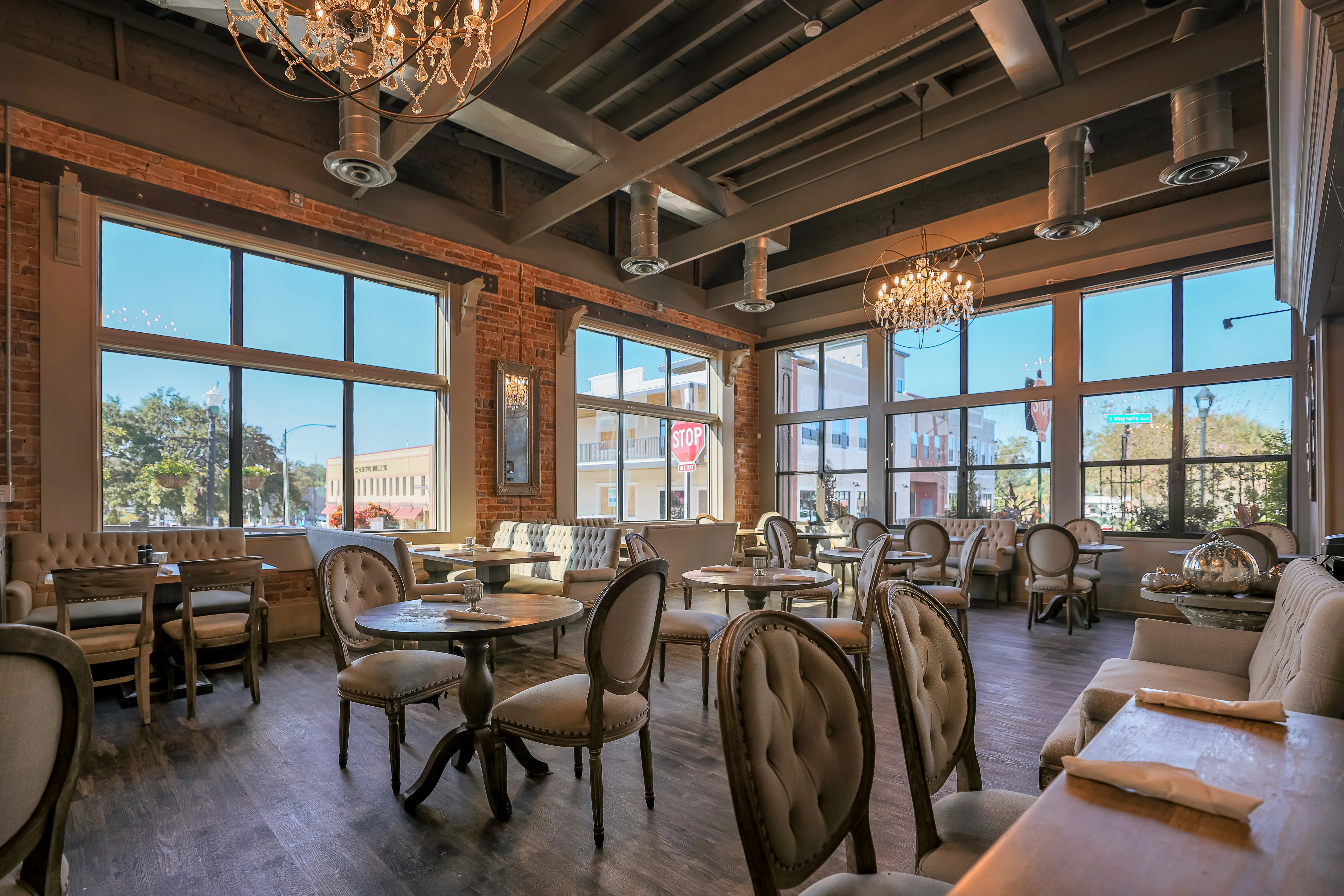 Cozy restaurant interior with elegant decor and large windows