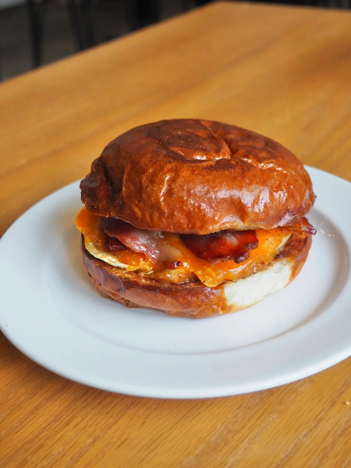 Classic American bacon cheeseburger with fried egg on a plate