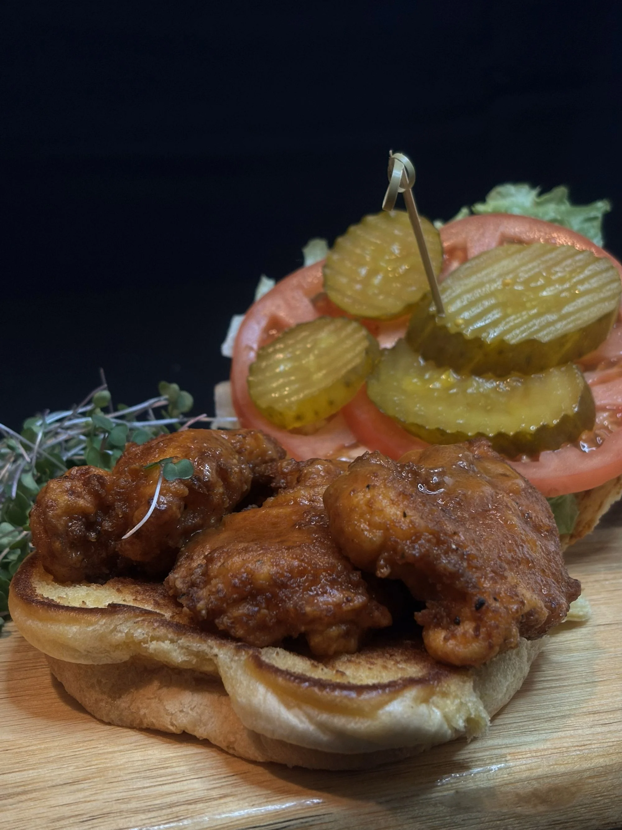 Southern fried chicken sandwich with pickles and tomatoes