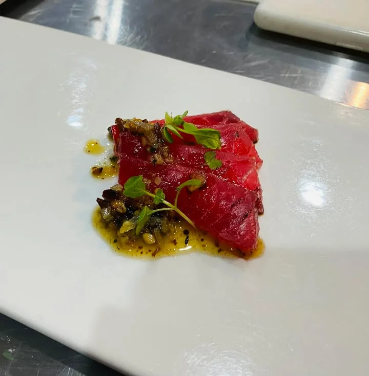 Sashimi-style tuna with herb garnish