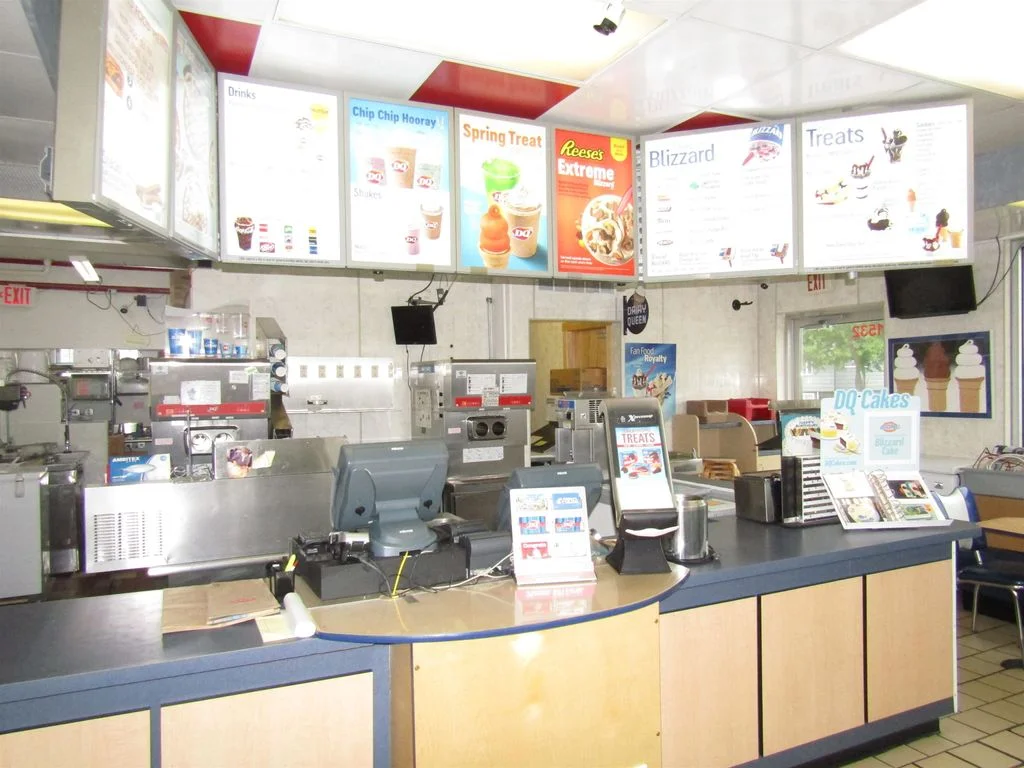Inside view of a Dairy Queen restaurant with menu boards and service counter