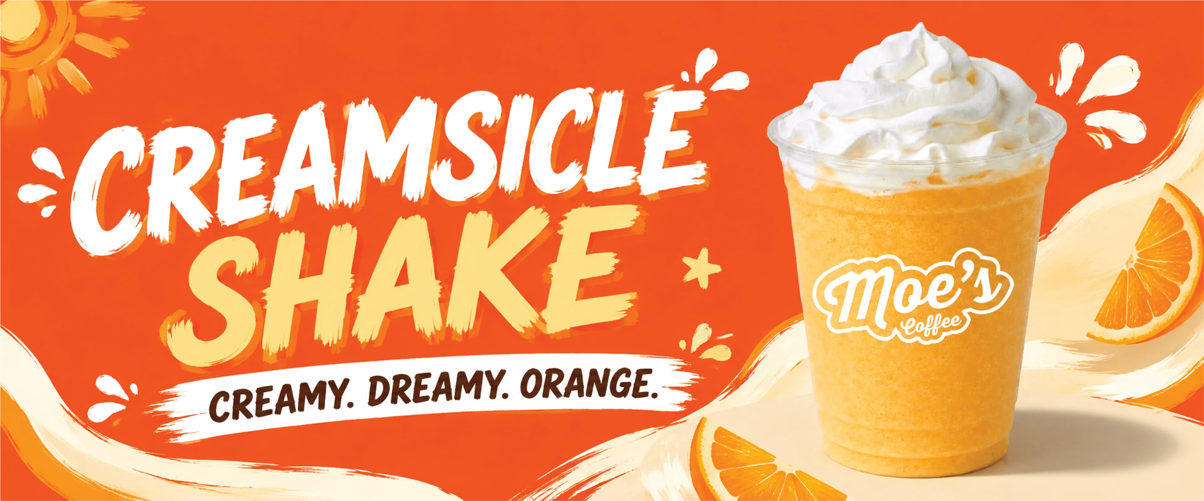 Creamsicle shake in a clear cup with whipped cream and orange background