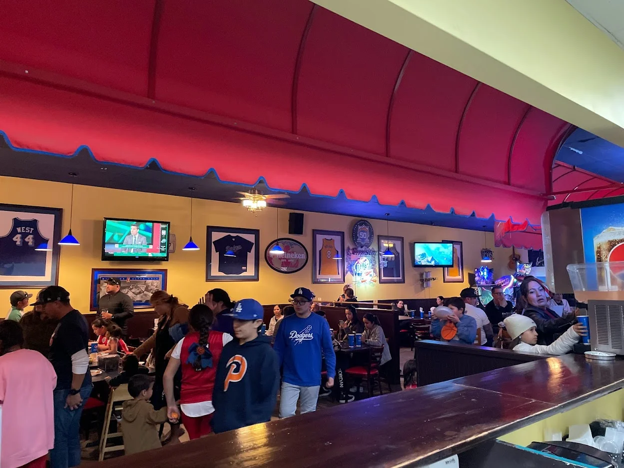Lively restaurant interior with sports decor and families dining