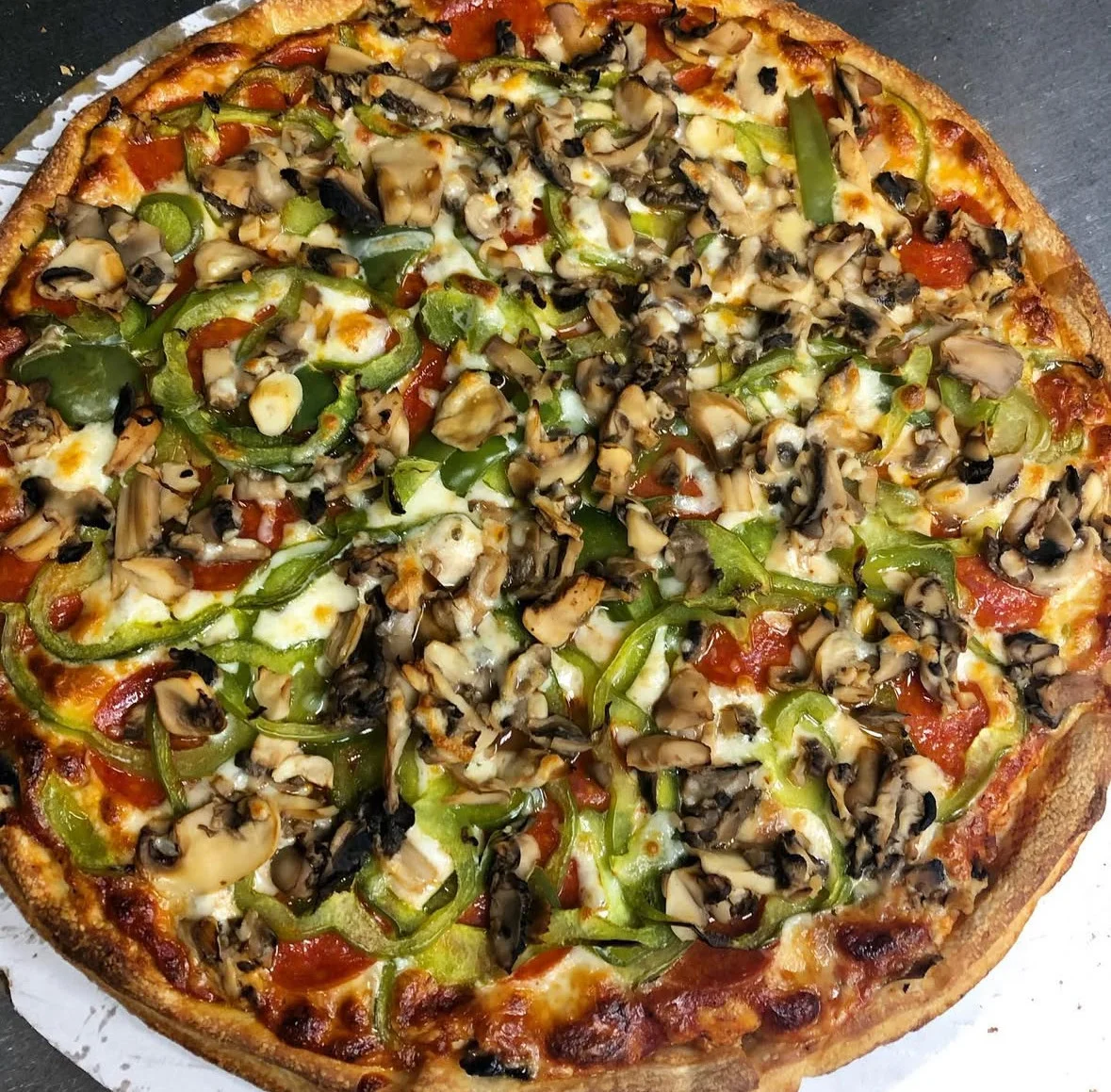 Vegetarian pizza topped with mushrooms and green peppers