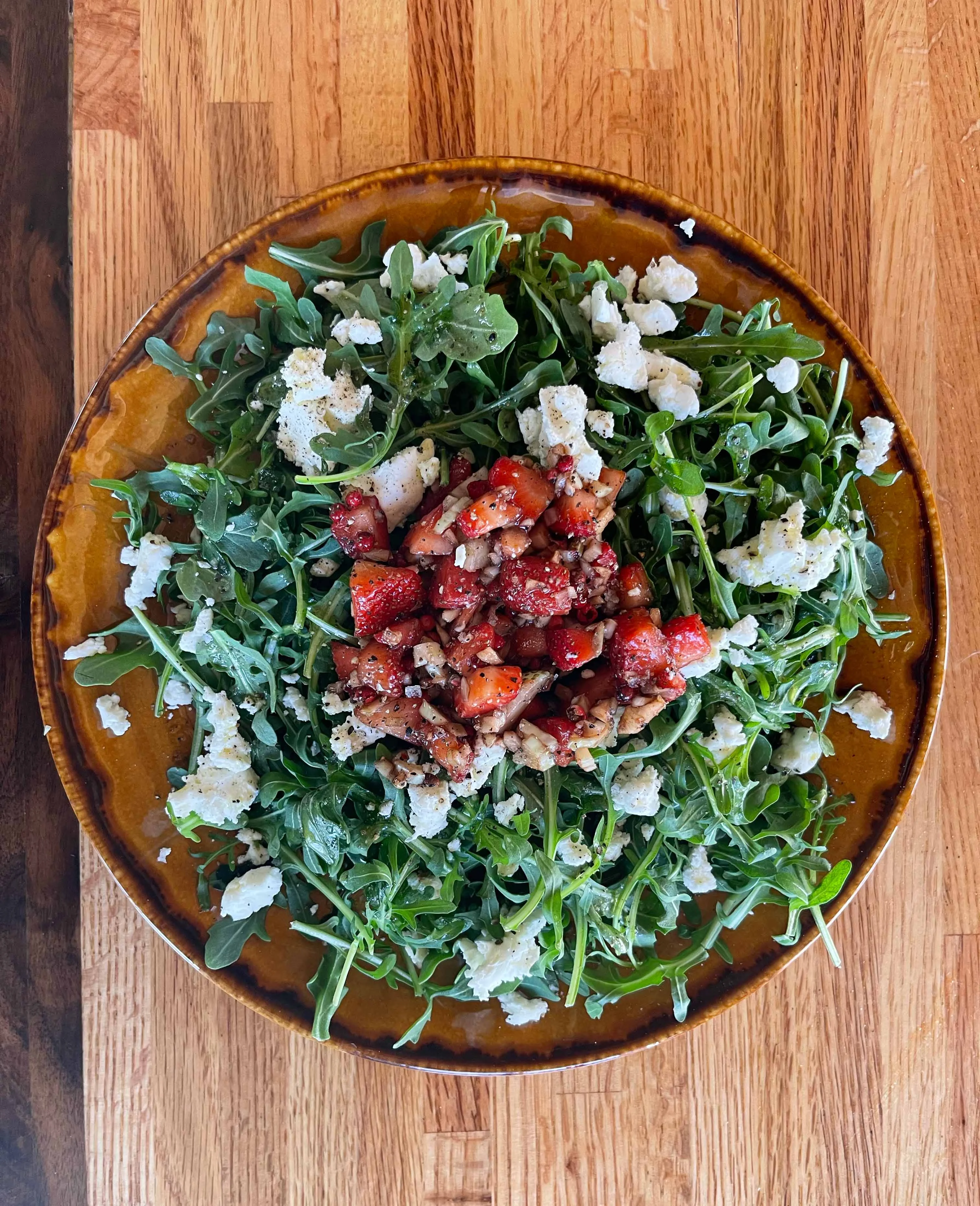 Fresh arugula salad with strawberries and goat cheese