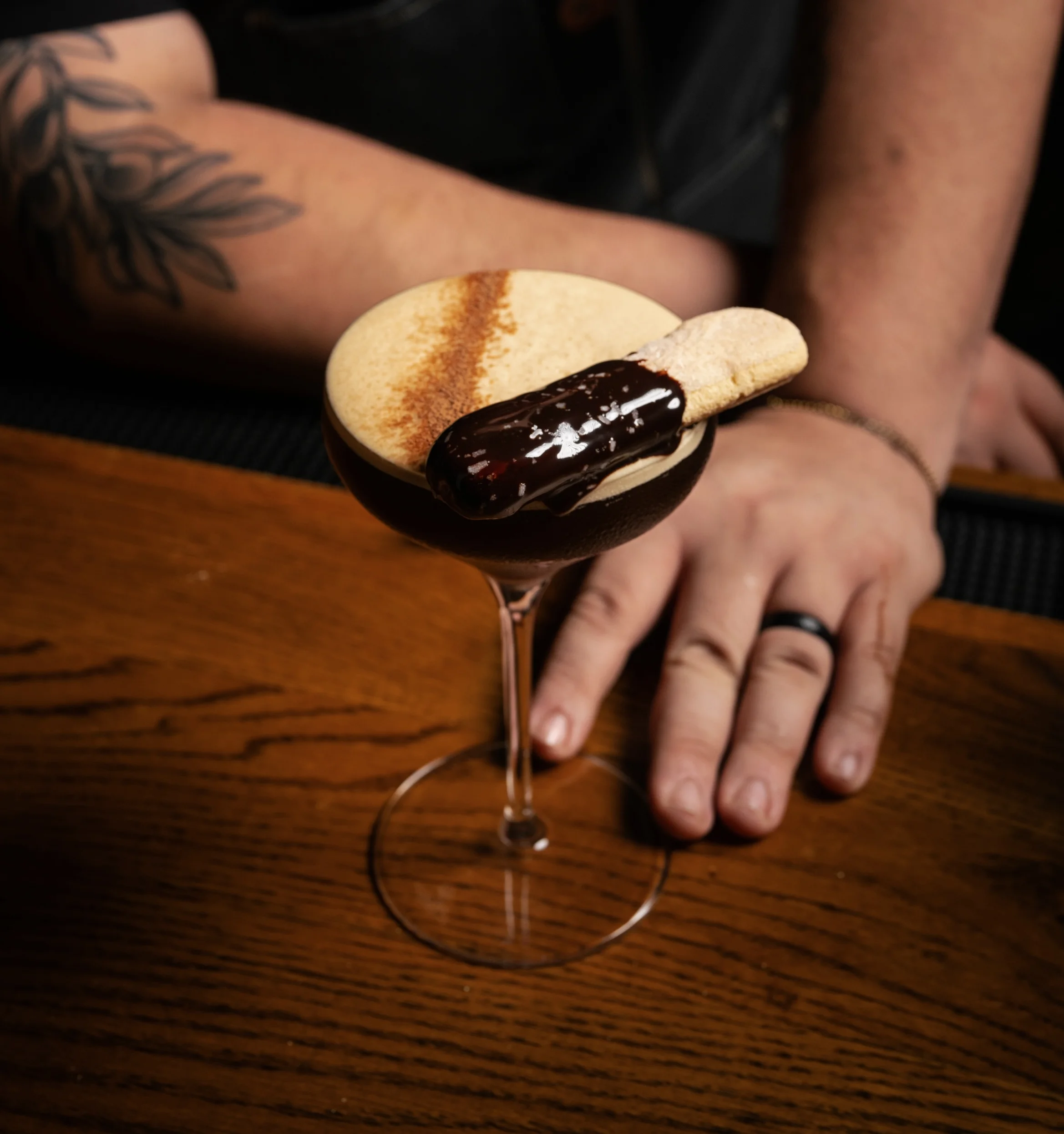 Craft cocktail with dried citrus garnishes on a wooden table