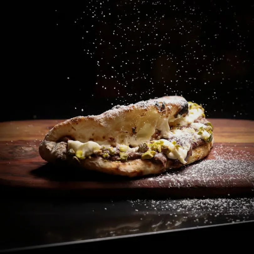 Delicious Turkish pide topped with cheese and herbs