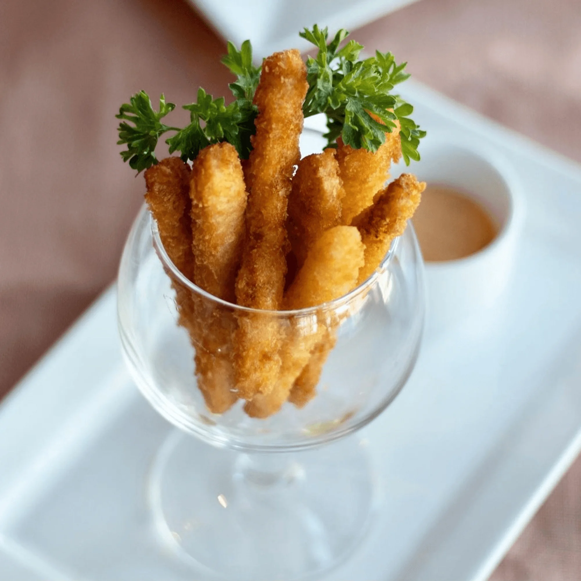 Crispy fried vegetable sticks served in a glass