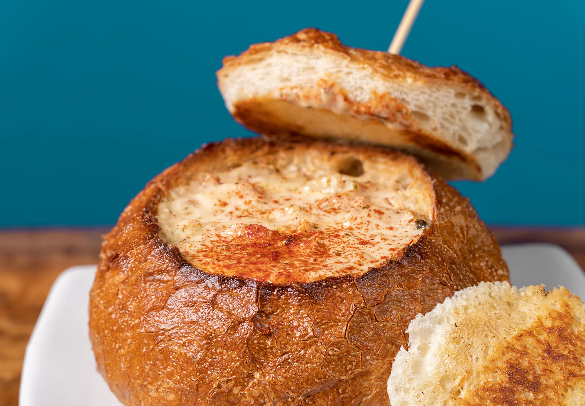 Creamy clam chowder in a sourdough bread bowl