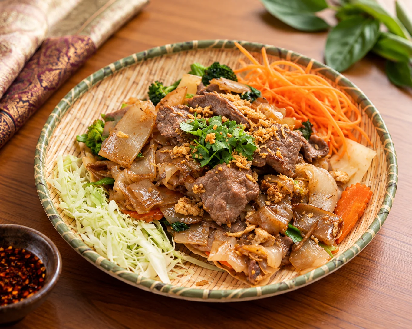 Vietnamese stir-fried beef rice noodles with fresh herbs and pickled vegetables