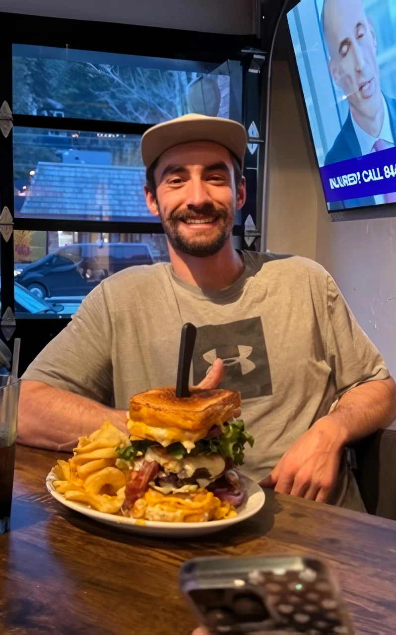 Giant American cheeseburger with fries in a casual dining setting