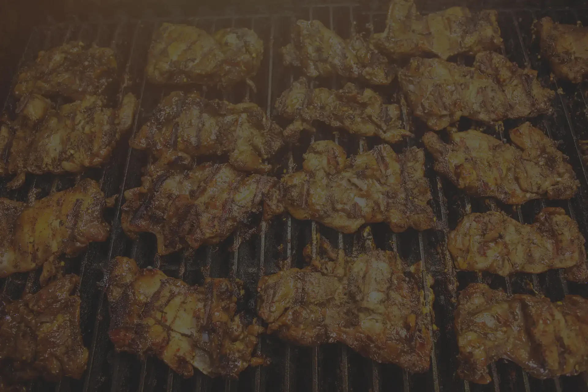 Grilled Jamaican jerk chicken on a barbecue